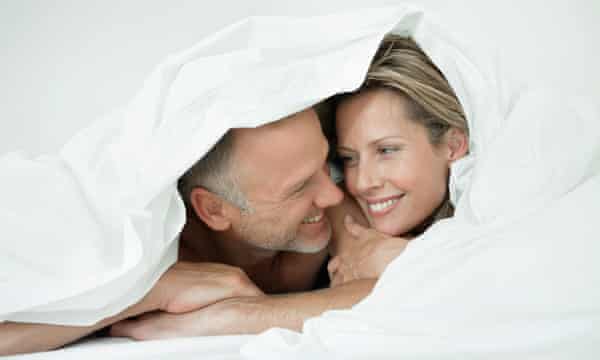 Couple wrapped in a duvetGettyImages-92793122