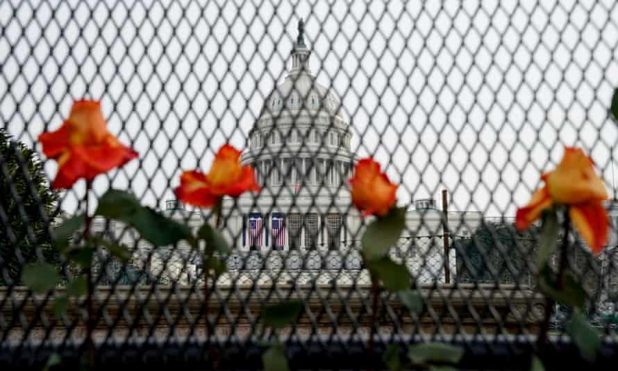 Flowers in security fencing days after supporters of Donald Trump stormed the Capitol