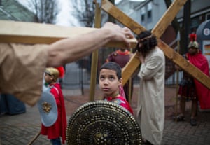 A young boy portraying a Roman soldier takes part in a staging of the Stations of the Cross in the streets of the Boston, Massachusetts, US.
