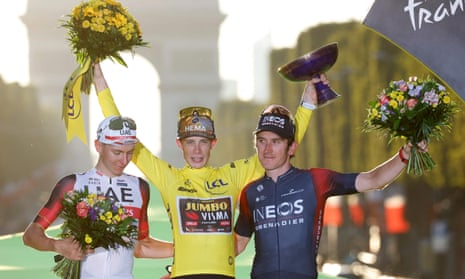Jonas Vingegaard celebrates winning the 2022 Tour de France with the yellow jersey he took from Tadej Pogacar (left). Geraint Thomas (right) finished third.