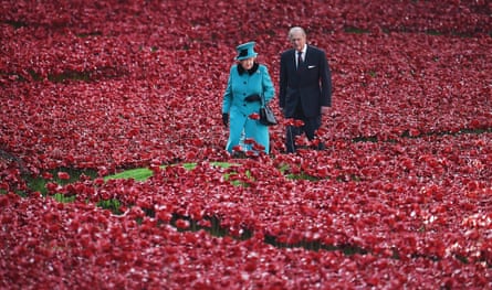 Queen Elizabeth and Prince Philip walking among the ceramic poppy installation at the Tower of London in 2014.