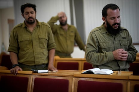Israeli infantry soldiers pray in a synagogue near the border during training in readiness for possible deployment across the border into Gaza in southern Israel.