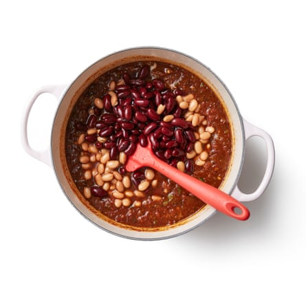 4 Add the beans, tomatoes and other flavourings. Drain the beans, reserving the liquid from the tins. Add the chilli paste, Marmite, tomatoes, coffee, beans and sugar to the pot, bring everything up to a simmer, then turn down the heat and leave to cook gently for about an hour, until the sauce has thickened to your liking, stirring; if it gets too dry, stir in some (or all) of the bean cooking liquidif it becomes too dry.