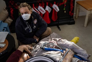 A community paramedic speaks to a patient during a home visit in White Plains, New York