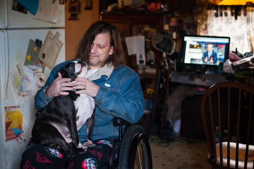 Sgt Ron Frye sits for a portrait with his dog at his home in Buckhannon. Frye is a veteran of several wars who now lives in a wheelchair after being hit by a roadside bomb in Iraq.