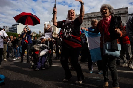 People hold signs outside the congress building