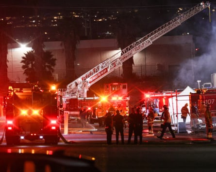 Emergency personnel work at the scene of the helicopter crash.