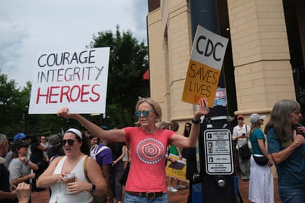 a women holding signs