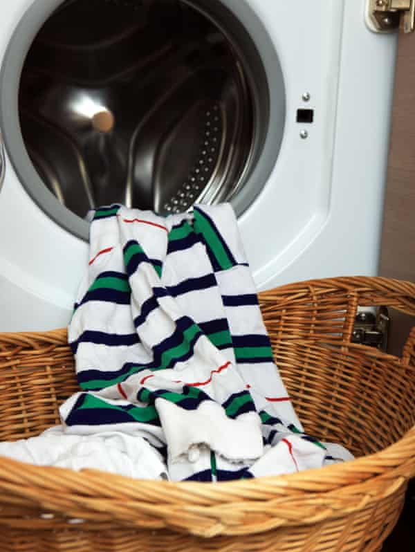 Clean washing coming out of a washing machine into a basket