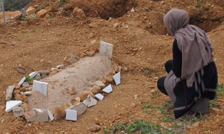 Aisha visits the infant’s grave.
