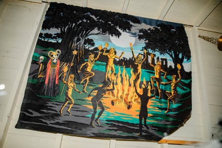 A tapestry depicting a ritual dance beside Stone Henge, inside witch-themed shop Cobwebs & Crystals in Burley village