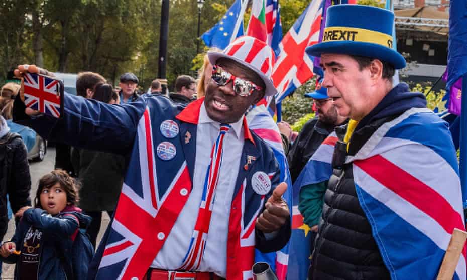 A Brexit supporter takes a selfie with a remain supporter during protests in Westminster in October 2019