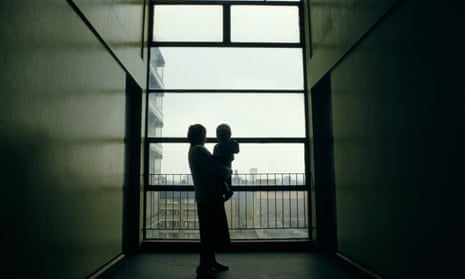 The silhouette of a 17 year old homeless girl with her baby in a corridor in a London building.