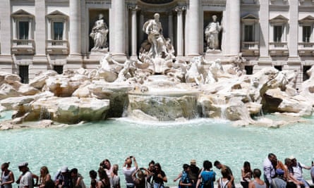 Tourists gather by the Trevi Fountain in Rome, Italy.