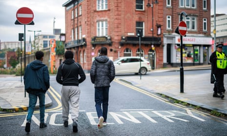 Three young men walking in Yorkshire seen from behind