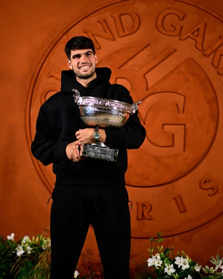 Carlos Alcaraz poses with trophy after the French Open final