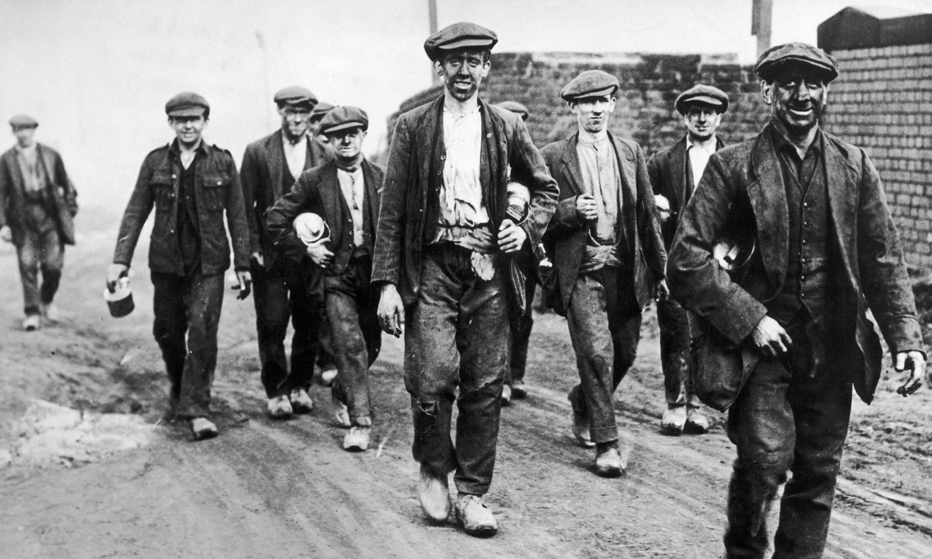 English coal miners walk home from work, circa 1925.