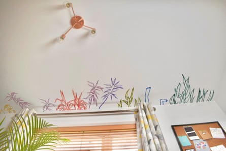 Miranda Forrester’s mural painted for her daughter’s bedroom. Leaf fronds cluster on the ceiling where it meets the wall, and a pair of swimmer’s feet disappear out of sight
