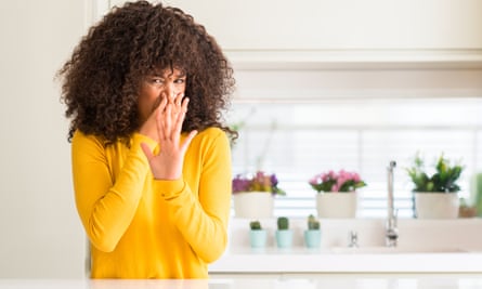 A woman is appalled at an ambient smell.