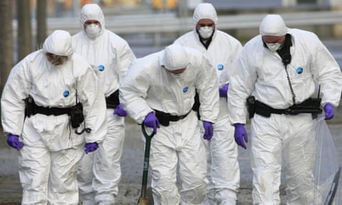 A Police forensic team search in front of the Policing Board headquarters in Belfast, Northern Ireland, on November 23, 2009.