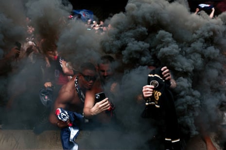 Paris Saint-Germain supporters watching a beam-back at the Parc des Princes celebrate their team’s second goal against Inter in the Champions League final.