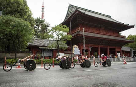 Brent Lakatos of Canada, David Weir of Britain, Aaron Pike of the US and Russian Vitalii Gritsenko pass the Zojoji Temple as they race through the city in the men’s marathon T54.