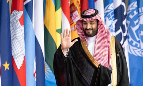 Mohammed bin Salman smiles and waves