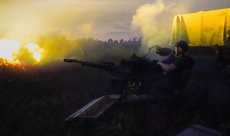Ukrainian servicemen shoot from an anti-aircraft gun in the early morning in Kharkiv.
