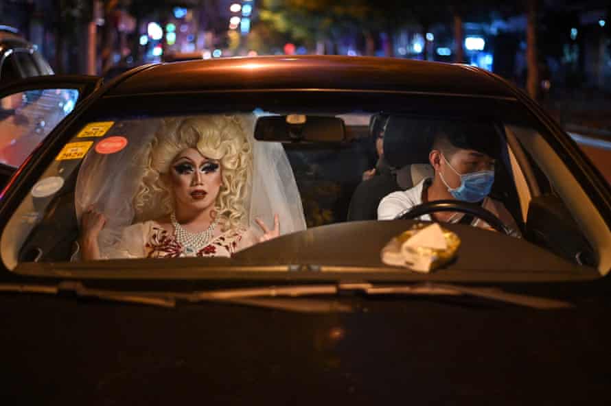 Drag queen Yan Anyu, or Miss Cream, rides in a taxi in Shanghai, 13 June