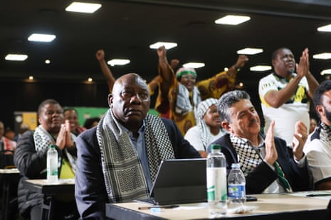 South African President Cyril Ramaphosa (L), and the deputy ambassador of Palestine, Bassam Elhussiny (R), watch the International Court of Justice (ICJ) ruling in Johannesburg.
