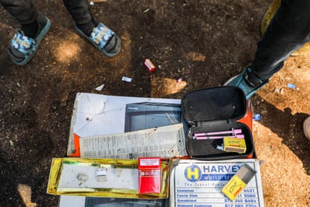 Drugs paraphernalia, including needles and matches, laid out on the ground
