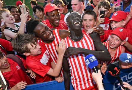 Gout Gout celebrates with school friends after winning the boys open 400m at the Greater Public Schools championships in Queensland.