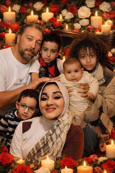 Family photo, using a filter that edges the frame with red flowers and candles