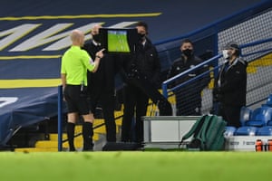 Referee Anthony Taylor checks the VAR monitor