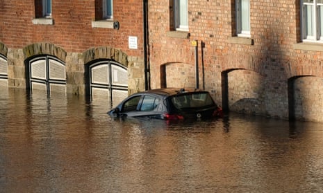 A parked car surrounded by water after levels rose in York, England. 