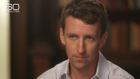 Serious-looking man with sandy hair looks intently at what we assume is an interviewer.