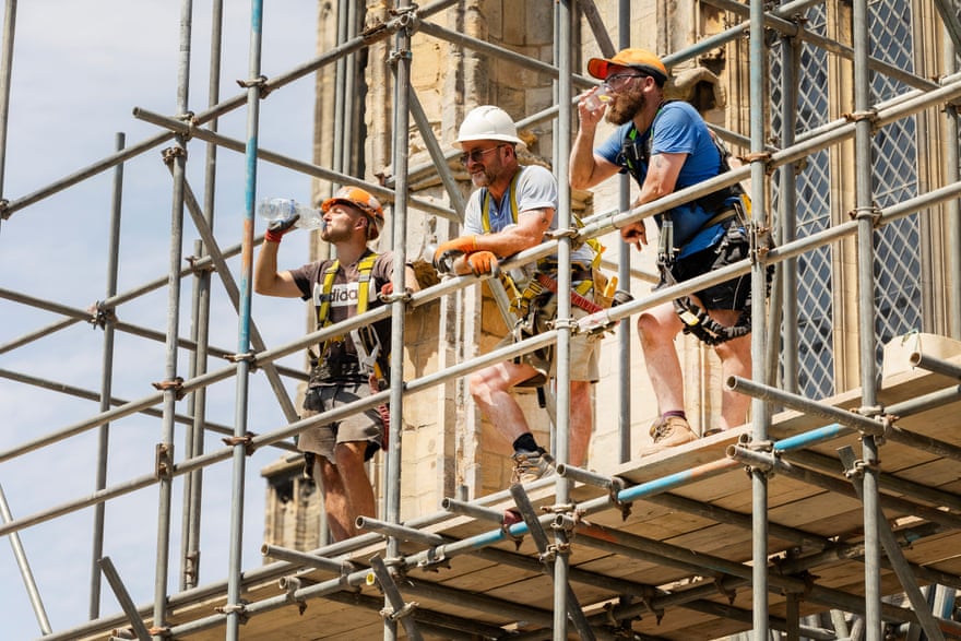 Scaffolders working on the restoration of St Botolph’s church in the midday heat.
