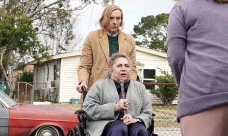Toni Collette as Macey, looking shifty, and Kathleen Turner, sitting in a wheelchair, as her wealthy Aunt Hilda, in The Estate.