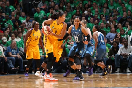 One basketball player covers another on the court