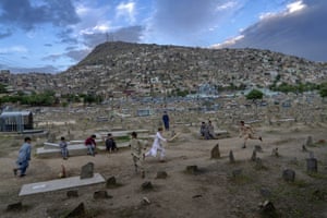 Afghan boys play cricket at a cemetery in Kabul