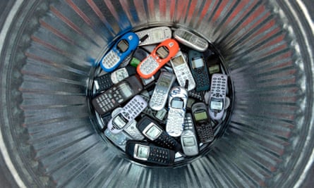 old mobile phones in a metal dustbin