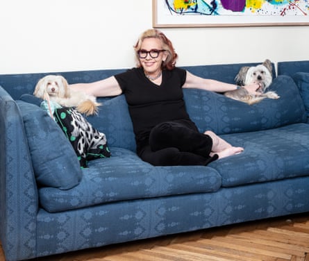 Molly Jong-Fast, the daughter of writer Erica Jong, sitting on a blue sofa with a dog either side of her