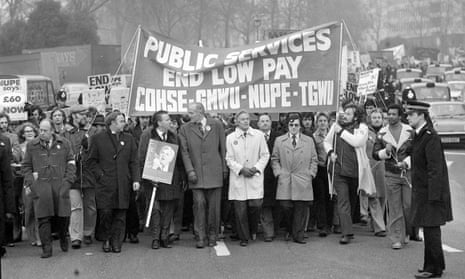 marching trade unionists with 'End low pay' banner