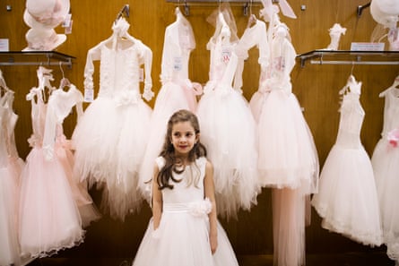 Irene poses during dress rehearsals for her first holy communion in the historic Naples shop Fratelli Martone, a specialist for a century in ceremonial clothing for children.