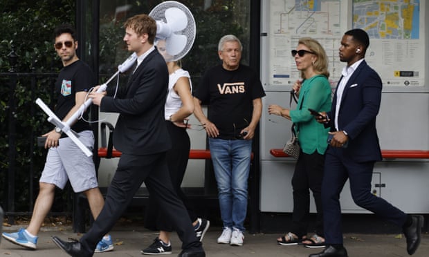 A person carries a fan through central London.