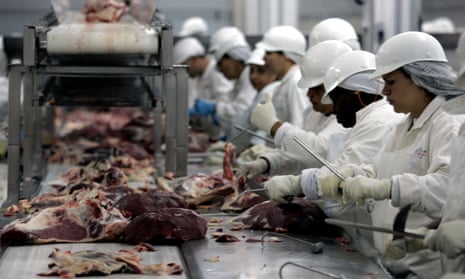 Butchers chop meat at a JBS packing plant in Sao Paulo, 9 September 2005
