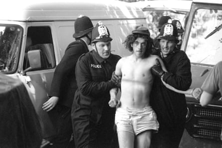 A traveller is arrested at the Battle of the Beanfield in Wiltshire, 1985