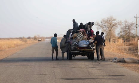 People fleeing the violence in Sudan load their belongings on to a vehicle after crossing the Joda border with South Sudan.