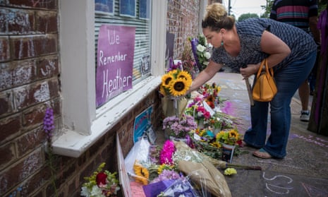 Sherrie Brown, from Charlottesville, lays flowers at a memorial for Heather Heyer, where she was struck and killed last year.