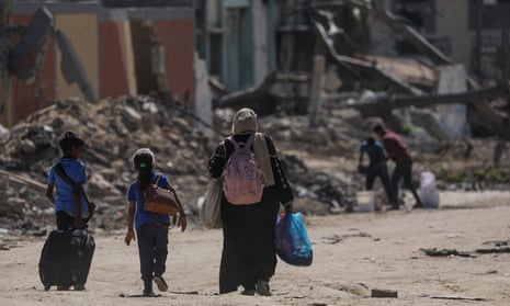 Internally displaced Palestinians return to the ruins of Khan Younis.